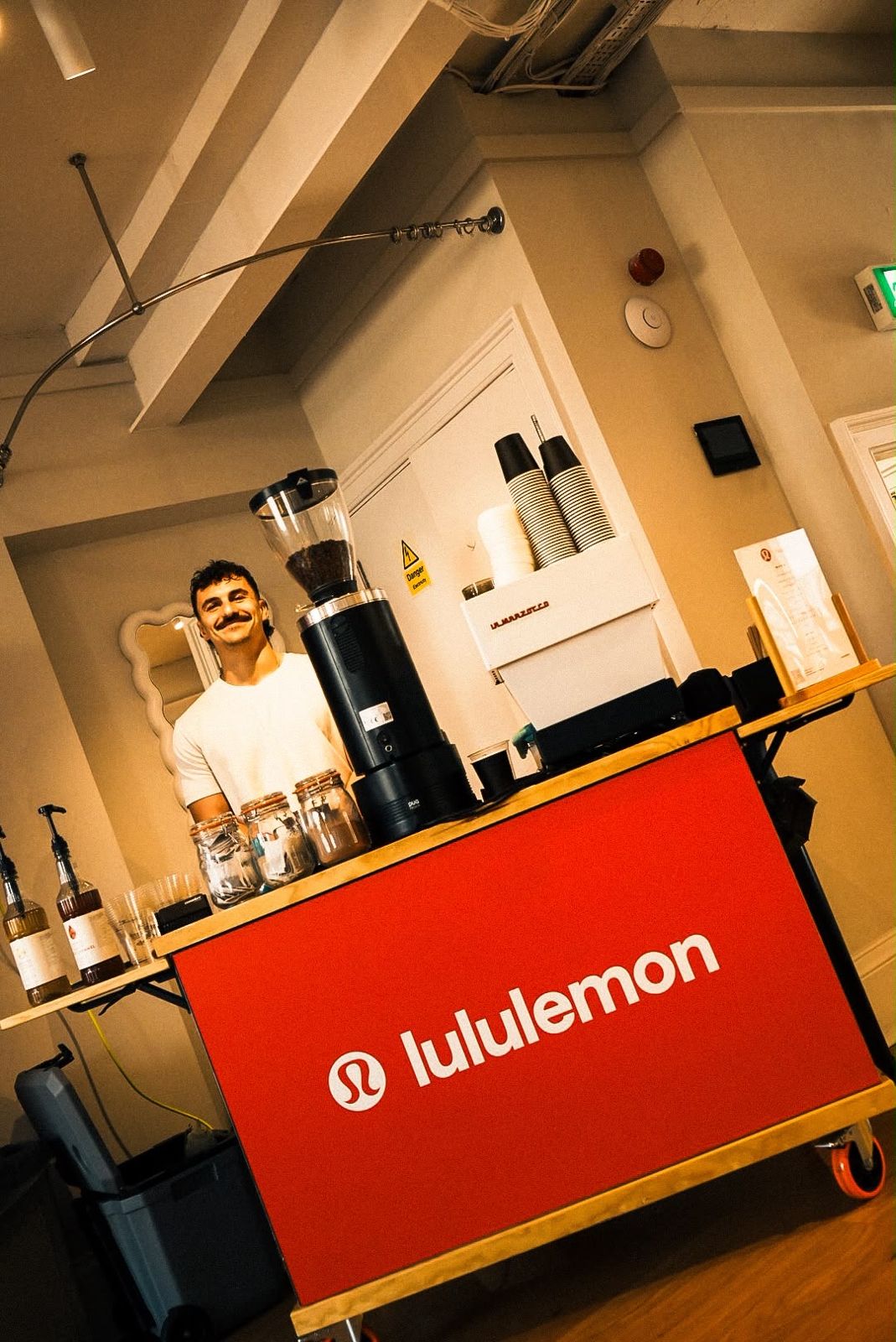 Damien behind the cart with a red lululemon front panel