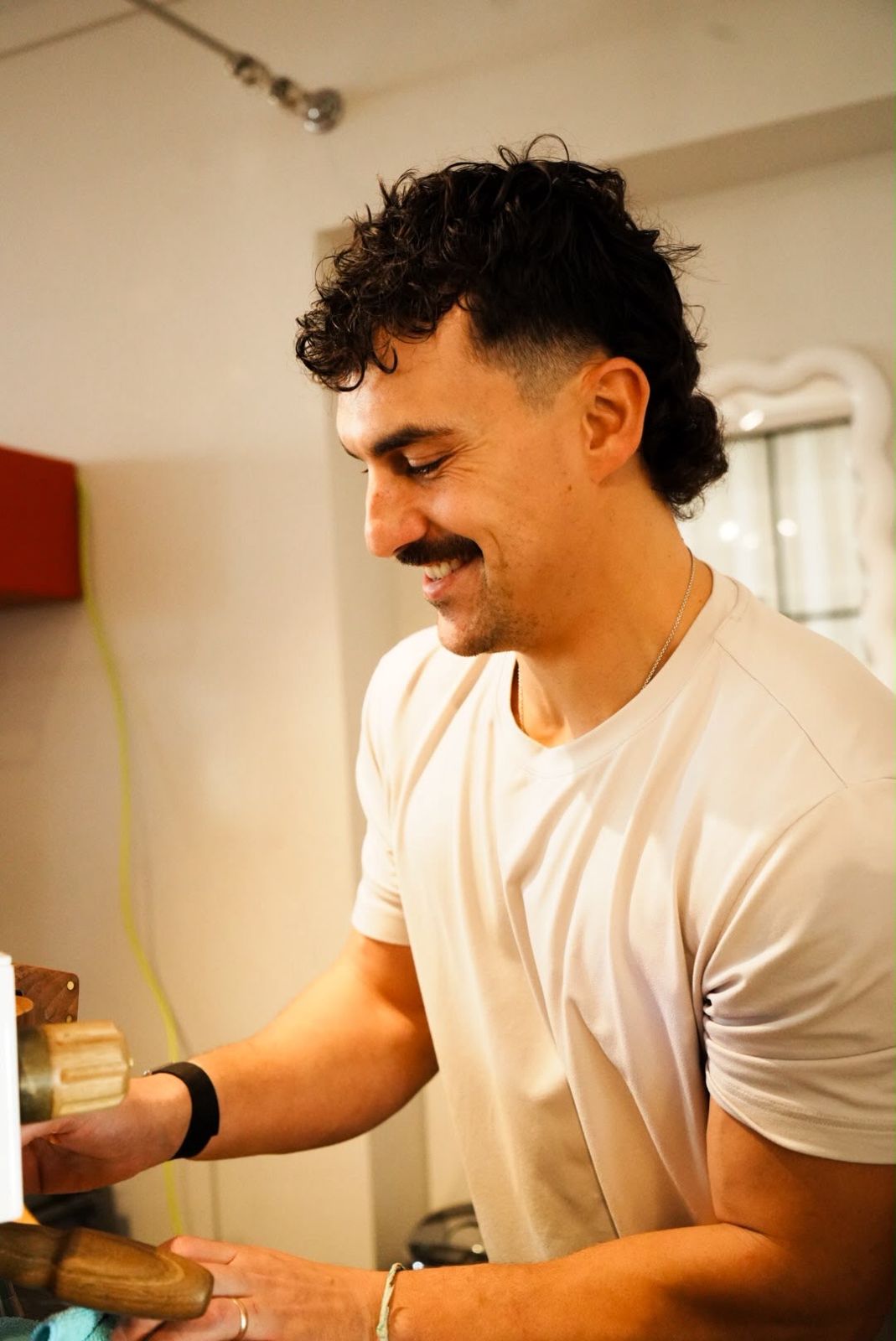 Damien smiling as he works the espresso machine