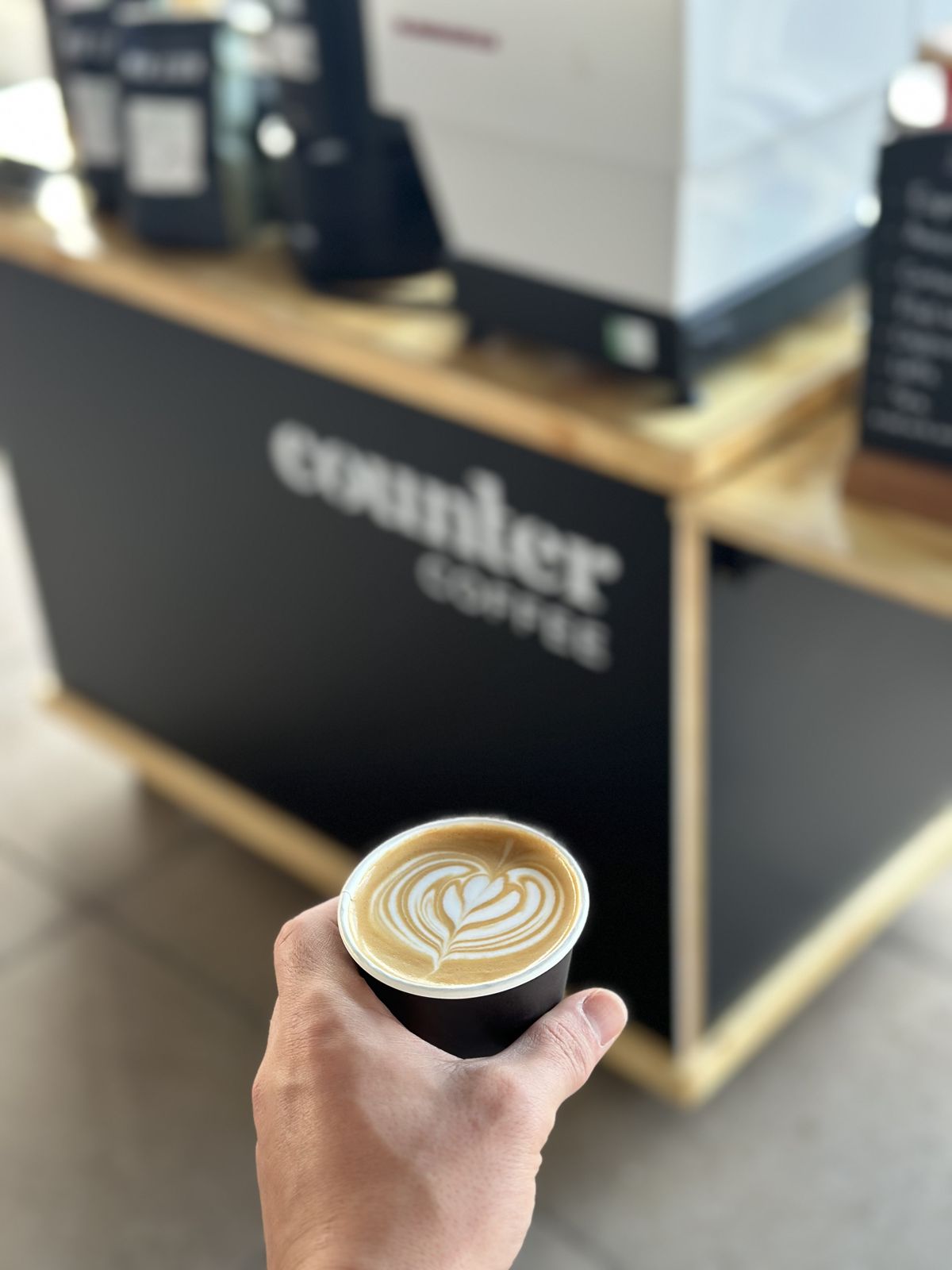 A latte held up in front of the cart
