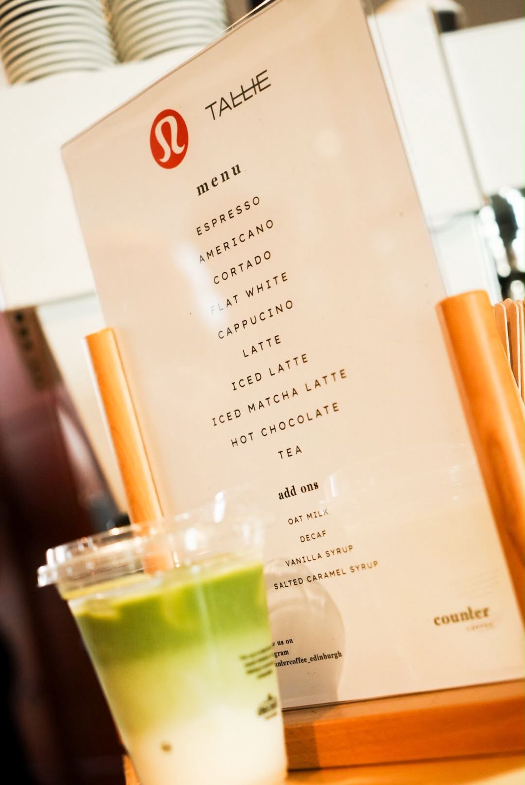 A custom co-branded drinks menu made for lululemon, with an iced matcha in front